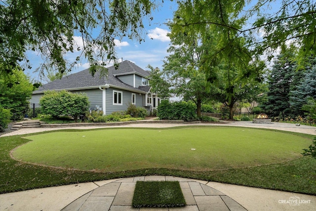 1112 Saratoga Ct, Naperville, IL 60564 - view of yard with a putting area and an outdoor fire pit