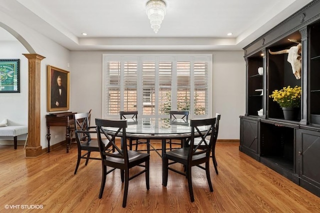 366 W Eggleston Ave, Elmhurst, IL 60126 - dining space featuring arched walkways, a tray ceiling, light wood finished floors, decorative columns, and recessed lighting