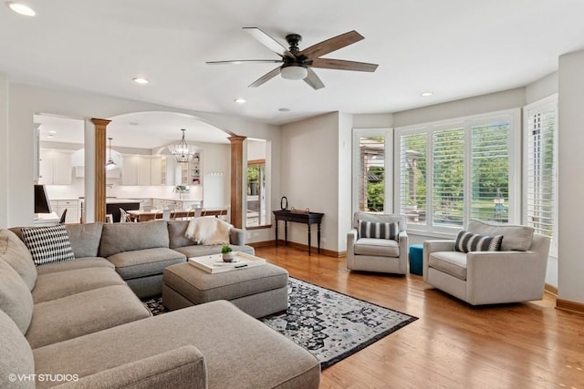366 W Eggleston Ave, Elmhurst, IL 60126 - living room featuring ornate columns, ceiling fan, light wood-style flooring, recessed lighting, and arched walkways