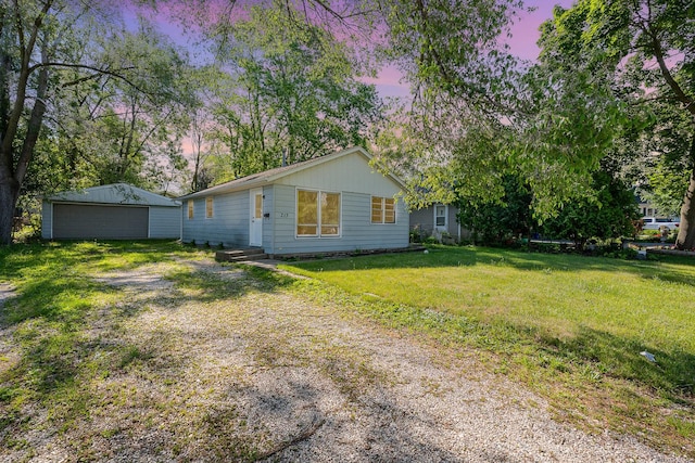 213 Brierhill Dr, Round Lake Park, IL 60073 - view of front facade featuring a detached garage, an outbuilding, and a yard