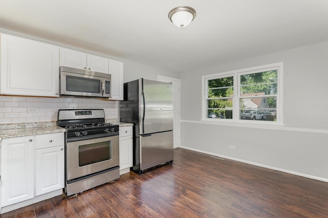 213 Brierhill Dr, Round Lake Park, IL 60073 - kitchen featuring appliances with stainless steel finishes, dark wood-style floors, decorative backsplash, white cabinetry, and light stone counters