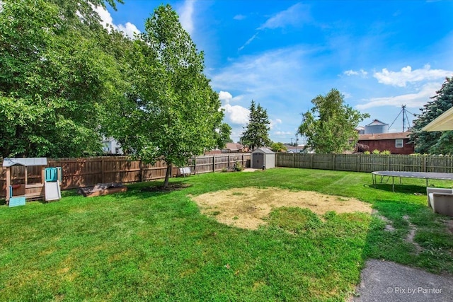 26 W Pine Ave, Cortland, IL 60112 - fenced backyard with a storage shed and a trampoline