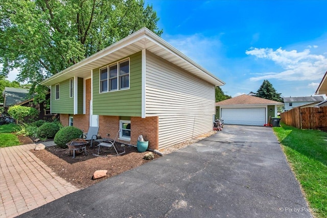 26 W Pine Ave, Cortland, IL 60112 - view of front of home featuring brick siding, an outdoor fire pit, an outdoor structure, and a garage