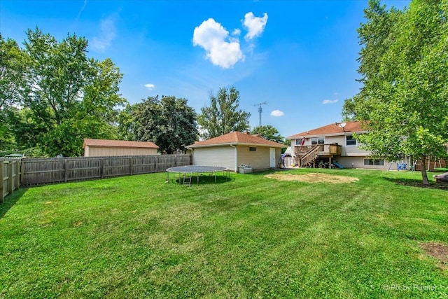26 W Pine Ave, Cortland, IL 60112 - fenced backyard with a trampoline, stairway, and a deck