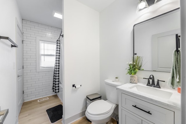 1030 Spruce St, Aurora, IL 60506 - bathroom featuring vanity, tiled shower, and wood finished floors
