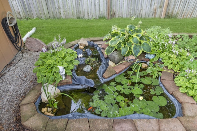 7 Walnut Dr, North Aurora, IL 60542 - exterior view of a vegetable garden and a small pond