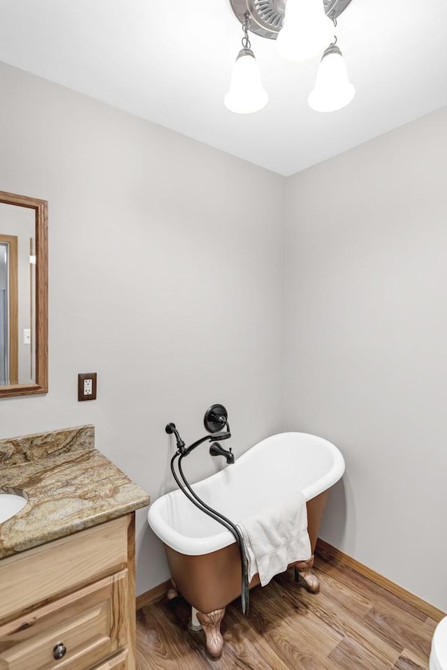 7 Walnut Dr, North Aurora, IL 60542 - bathroom with vanity, a freestanding bath, and wood finished floors