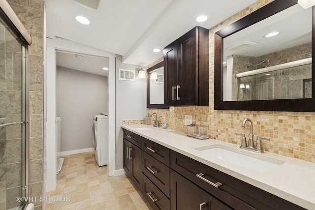 6848 N Oriole Ave, Chicago, IL 60631 - full bath featuring independent washer and dryer, double vanity, a stall shower, recessed lighting, and backsplash