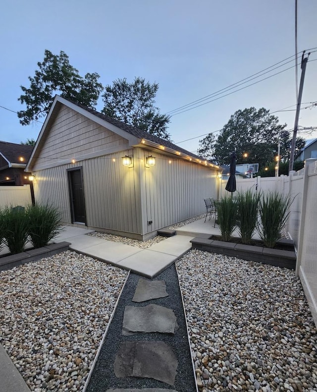 6848 N Oriole Ave, Chicago, IL 60631 - view of side of home with board and batten siding and a patio area