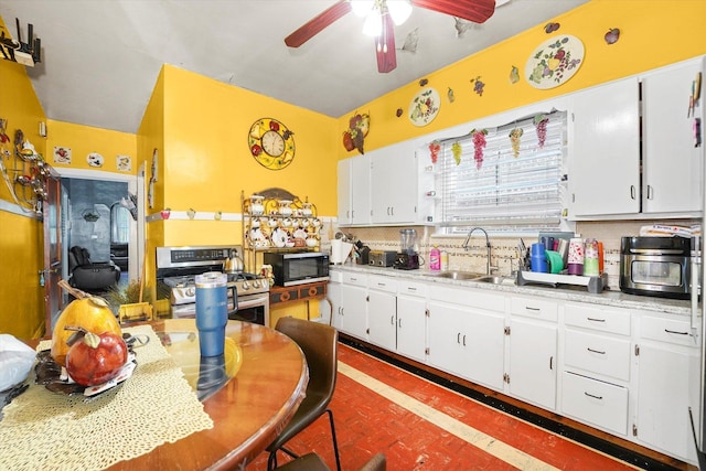 1916 N Lowell Ave, Chicago, IL 60639 - kitchen featuring gas range, black microwave, ceiling fan, decorative backsplash, and white cabinets