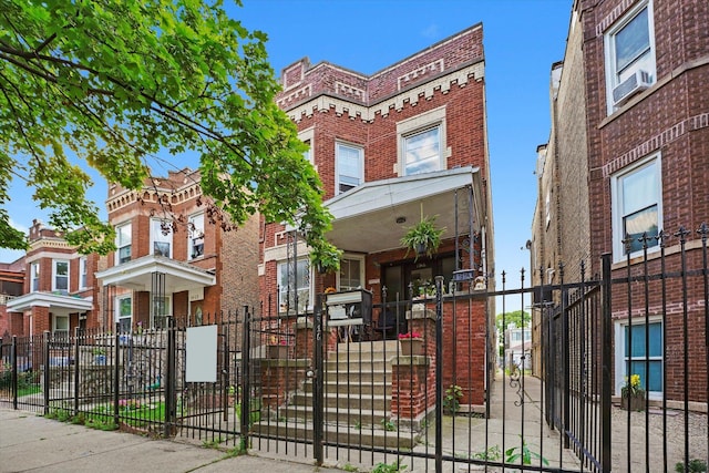 1916 N Lowell Ave, Chicago, IL 60639 - view of front facade with a fenced front yard, brick siding, and a gate