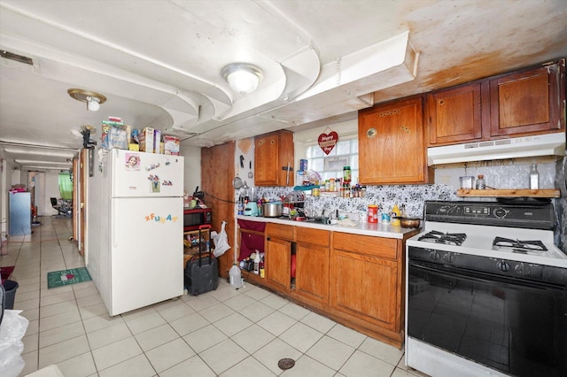 1916 N Lowell Ave, Chicago, IL 60639 - kitchen featuring white appliances, under cabinet range hood, brown cabinets, light countertops, and light tile patterned flooring