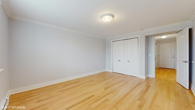 6333 N Milwaukee Ave Unit 2E, Chicago, IL 60646 - unfurnished bedroom featuring light wood finished floors, ornamental molding, baseboard heating, and a closet