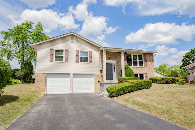 815 Concord Cv, Hoffman Estates, IL 60192 - raised ranch featuring brick siding, driveway, a garage, and a front yard