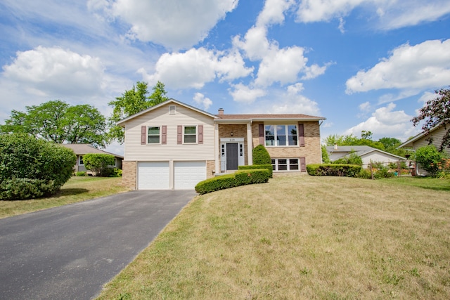 815 Concord Cv, Hoffman Estates, IL 60192 - raised ranch with brick siding, a garage, asphalt driveway, a front lawn, and a chimney