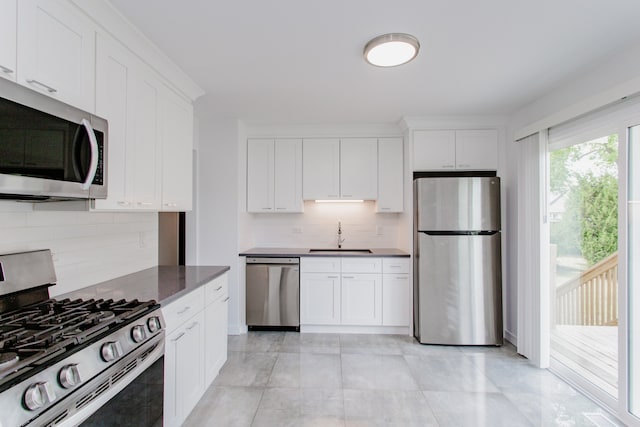 815 Concord Cv, Hoffman Estates, IL 60192 - kitchen with appliances with stainless steel finishes, backsplash, and white cabinetry