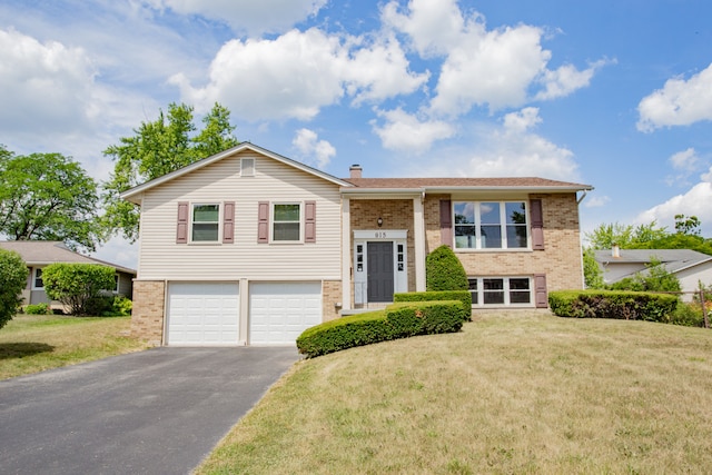 815 Concord Cv, Hoffman Estates, IL 60192 - split foyer home with brick siding, driveway, an attached garage, and a front lawn