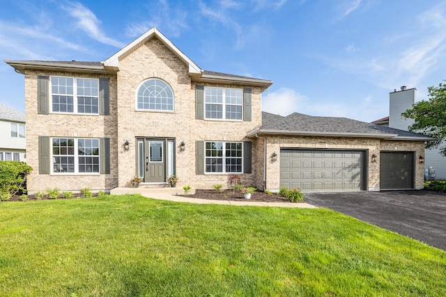 25030 Round Barn Rd, Plainfield, IL 60585 - view of front facade featuring driveway, a garage, a front lawn, brick siding, and a chimney