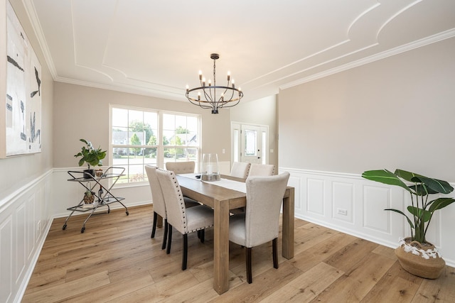 25030 Round Barn Rd, Plainfield, IL 60585 - dining room featuring ornamental molding, a chandelier, light wood-type flooring, a wainscoted wall, and a decorative wall