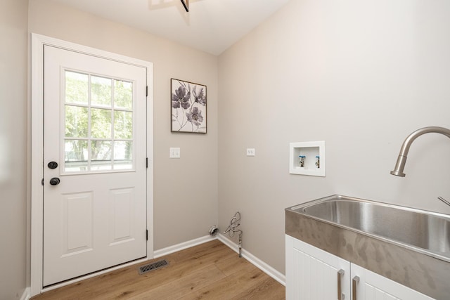 25030 Round Barn Rd, Plainfield, IL 60585 - laundry room featuring cabinet space, light wood finished floors, and washer hookup