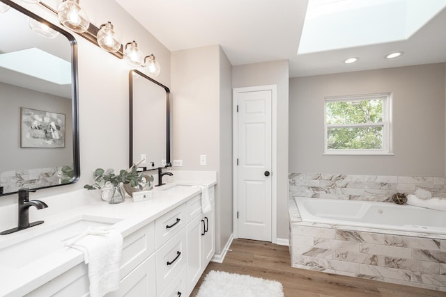 25030 Round Barn Rd, Plainfield, IL 60585 - full bath featuring double vanity, a garden tub, wood finished floors, recessed lighting, and a skylight
