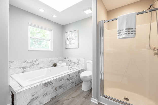 25030 Round Barn Rd, Plainfield, IL 60585 - bathroom with wood finished floors, a bath, a shower stall, and recessed lighting
