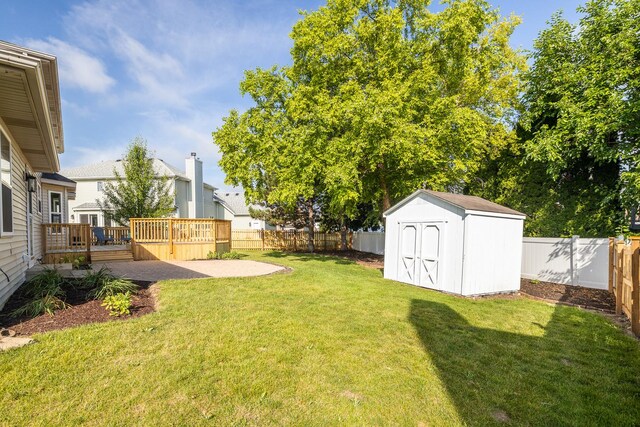 25030 Round Barn Rd, Plainfield, IL 60585 - fenced backyard featuring a deck, a storage unit, and a patio area