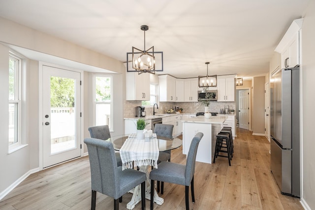 25030 Round Barn Rd, Plainfield, IL 60585 - dining space with a chandelier, light wood-style flooring, and healthy amount of natural light