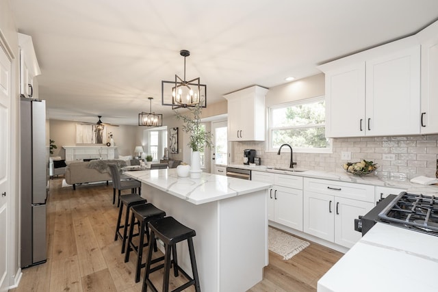 25030 Round Barn Rd, Plainfield, IL 60585 - kitchen with open floor plan, stainless steel appliances, light stone countertops, a center island, and tasteful backsplash