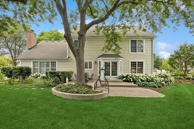 1219 N Lakeview Ct, Palatine, IL 60067 - rear view of house with a patio, a lawn, a chimney, and roof with shingles