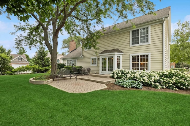 1219 N Lakeview Ct, Palatine, IL 60067 - rear view of property with a patio, a yard, a chimney, and roof with shingles