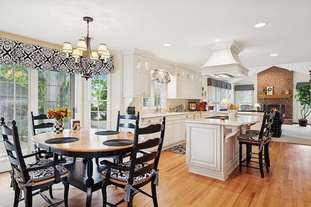 1219 N Lakeview Ct, Palatine, IL 60067 - dining room featuring a chandelier, light wood-style flooring, recessed lighting, and a fireplace
