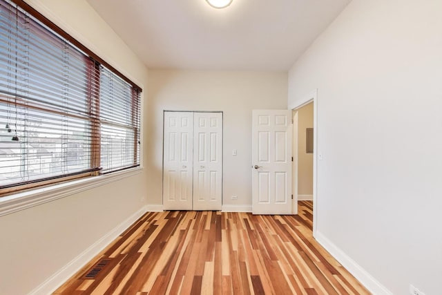 1634 N Wolcott Ave Unit 3, Chicago, IL 60622 - unfurnished bedroom with light wood finished floors and a closet