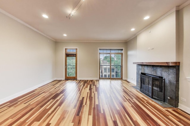 1634 N Wolcott Ave Unit 3, Chicago, IL 60622 - unfurnished living room featuring ornamental molding, wood finished floors, a tile fireplace, and recessed lighting