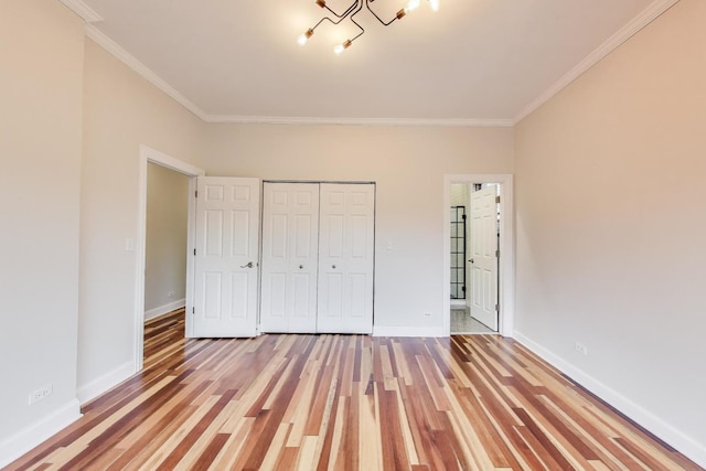 1634 N Wolcott Ave Unit 3, Chicago, IL 60622 - unfurnished bedroom featuring crown molding, light wood-style floors, a closet, a chandelier, and ensuite bath