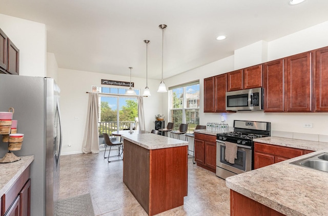 15373 Sheffield Square Pkwy, Orland Park, IL 60462 - kitchen with appliances with stainless steel finishes, light countertops, a kitchen island, decorative light fixtures, and recessed lighting