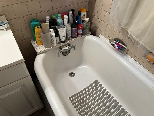 4721 W Warwick Ave, Chicago, IL 60641 - bathroom view of tile walls, a tub to relax in, and decorative backsplash
