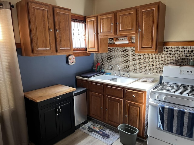 4721 W Warwick Ave, Chicago, IL 60641 - kitchen featuring gas range gas stove, tasteful backsplash, wood counters, and brown cabinets