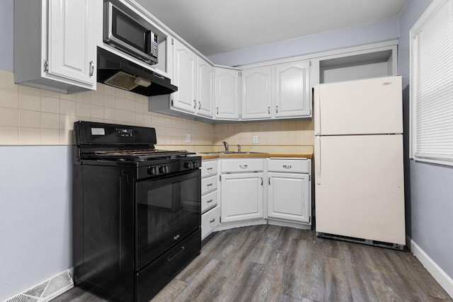 3226 Carolina Ave, Rockford, IL 61108 - kitchen with freestanding refrigerator, gas stove, under cabinet range hood, white cabinets, and stainless steel microwave