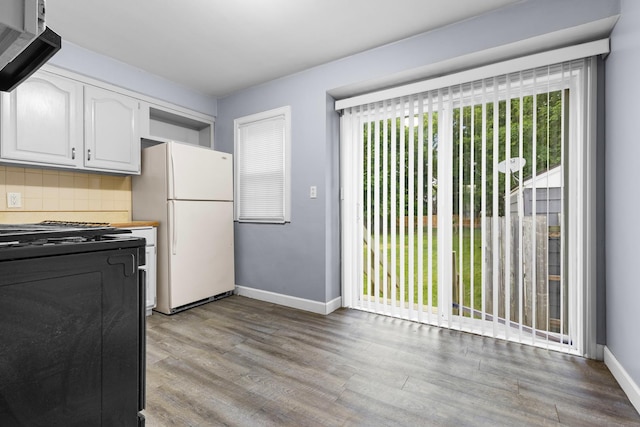 3226 Carolina Ave, Rockford, IL 61108 - kitchen featuring freestanding refrigerator, black gas range oven, healthy amount of natural light, and white cabinetry