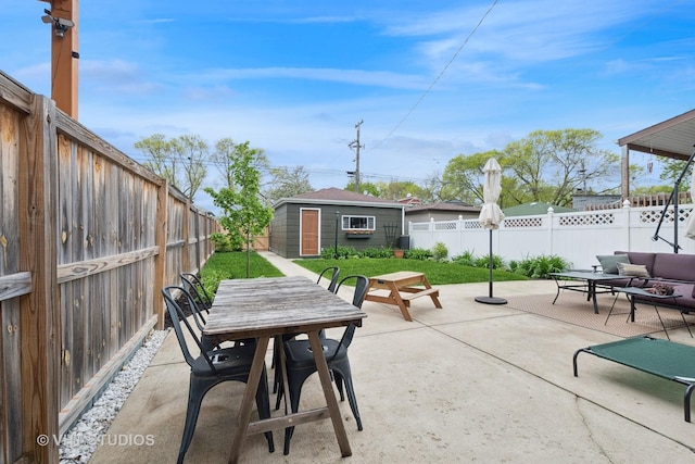 5747 W Grace St, Chicago, IL 60634 - fenced backyard featuring a patio, outdoor dining space, an outbuilding, and an outdoor living space