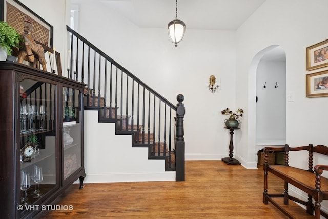 5747 W Grace St, Chicago, IL 60634 - foyer with arched walkways, wood finished floors, and stairway
