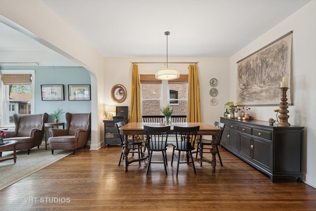 5747 W Grace St, Chicago, IL 60634 - dining space featuring dark wood finished floors and arched walkways
