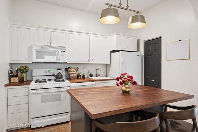 5747 W Grace St, Chicago, IL 60634 - kitchen featuring butcher block countertops, white appliances, and white cabinets