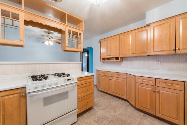 525 Bunning Dr, Downers Grove, IL 60516 - kitchen featuring white gas stove, light countertops, ceiling fan, glass insert cabinets, and wallpapered walls