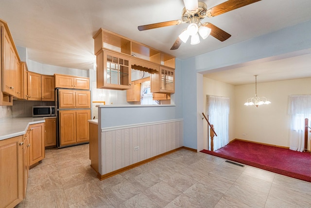 525 Bunning Dr, Downers Grove, IL 60516 - kitchen with stainless steel microwave, light countertops, ceiling fan, a chandelier, and glass insert cabinets