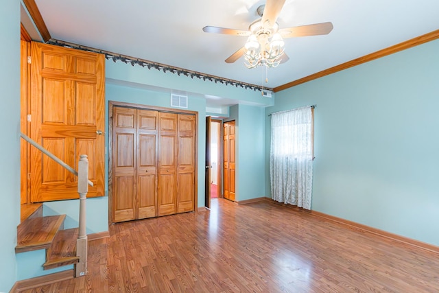525 Bunning Dr, Downers Grove, IL 60516 - unfurnished bedroom with light wood finished floors, a closet, ornamental molding, and a ceiling fan