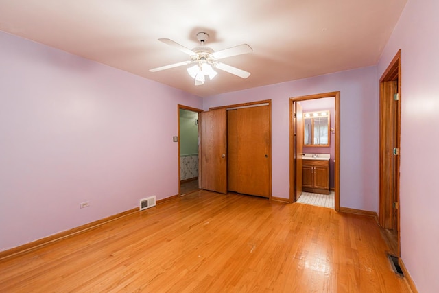 525 Bunning Dr, Downers Grove, IL 60516 - unfurnished bedroom featuring light wood-style flooring, a closet, connected bathroom, and ceiling fan