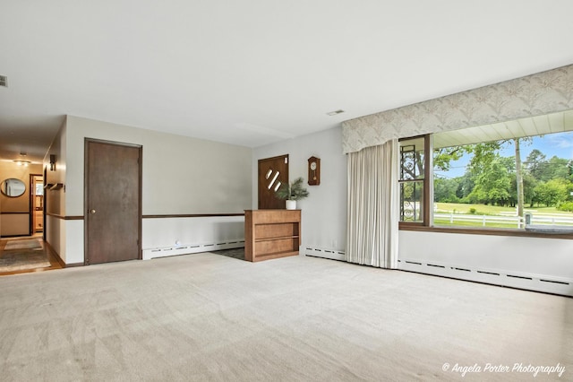 2514 Cuhlman Rd, Mchenry, IL 60051 - unfurnished living room featuring a baseboard heating unit, plenty of natural light, and carpet floors