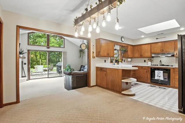 2514 Cuhlman Rd, Mchenry, IL 60051 - kitchen with black appliances, under cabinet range hood, light colored carpet, brown cabinetry, and lofted ceiling